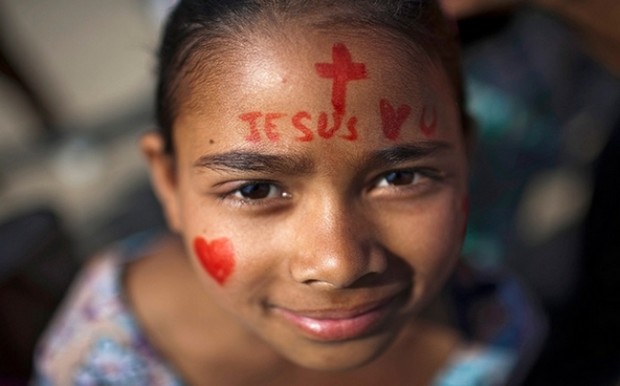 A Nepalese Christian girl with a painted face during a religious gathering