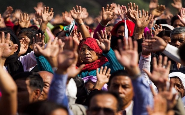 A group of Nepalese Christian pray at a religious gathering