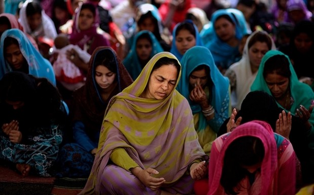 Christians pray at an Easter Mass in a Christian neighbourhood in Islamabad