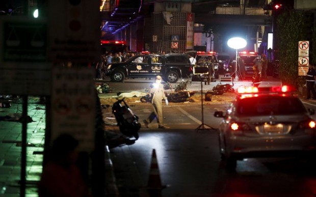 ATTENTION EDITORS - VISUAL COVERAGE OF SCENES OF DEATH AND INJURY The body of a victim covered with a sheet is seen as security forces and emergency workers gather at the scene of the blast in central Bangkok August 17, 2015. The bomb planted at one of the Thai capital's most renowned shrines on Monday killed 16 people, including three foreign tourists, and wounded scores in an attack the government called a bid to destroy the economy. REUTERS/Chaiwat SubprasomTEMPLATE OUT